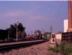 A southbound train awaits the arrival of a northbound at the south end of the yard